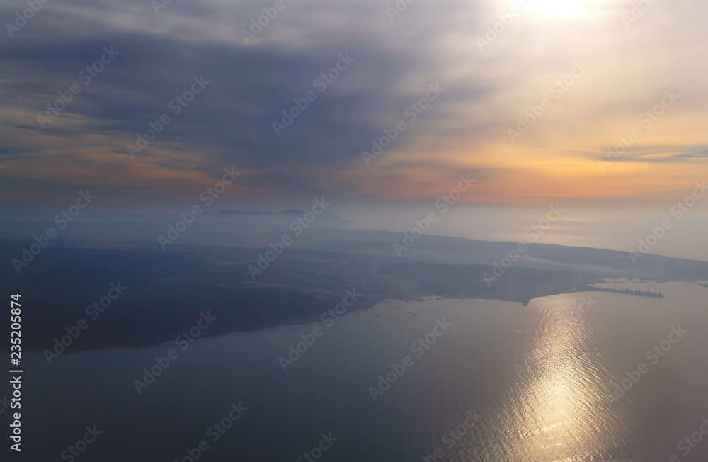 view from the plane to the island of Sakhalin, the mountains and the sea with the seaport