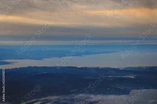 view from the plane to the island of Sakhalin, the mountains and the sea with the seaport
