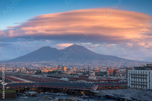 Naples city in the evening sunny light and Mount Vesuvius with beautiful unusual cloud background, Italy