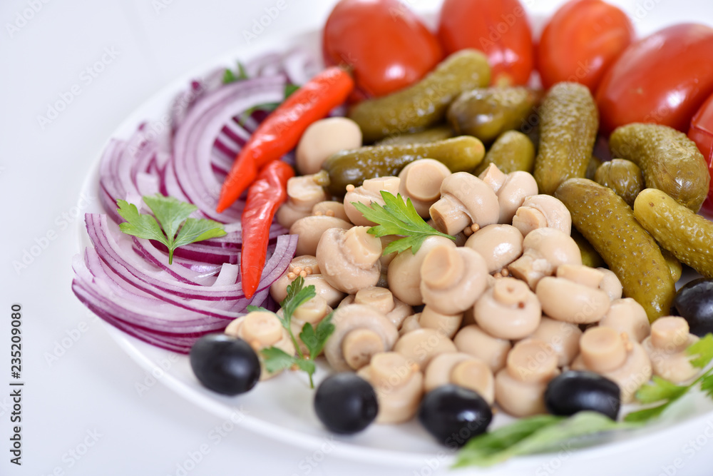 Pickles in assortment on a plate. Restaurant dish. Pickles in assortment on a plate. Restaurant dish.