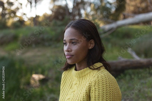 Young brunette woman standing in forest photo