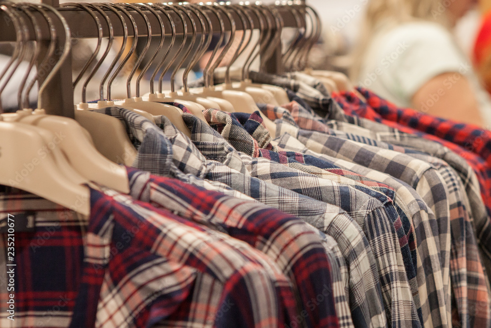 Clothes hang on a shelf . Cloth Hangers with Shirts. Men's stylish clothes Clothes hang on a shelf . Cloth Hangers with Shirts. Men's stylish clothes