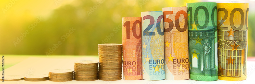 Histogram of coins and bamknotes on a green background. Concept of growth of currency Histogram of coins and bamknotes on a green background. Concept of growth of currency