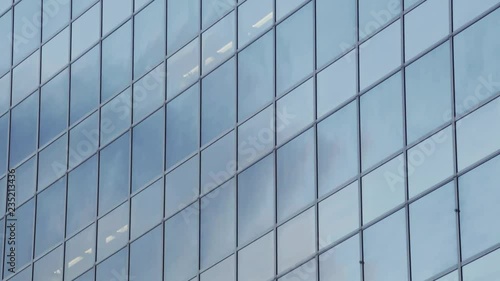 Wallpaper Mural A real time vertical panning shot of an office building with a glass facade reflecting a blue sky with clouds. Torontodigital.ca
