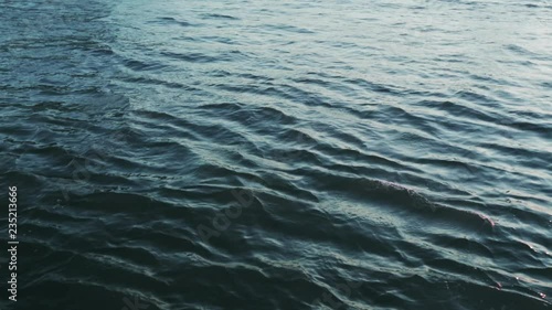 Calm water - small river or lake waves at dusk.