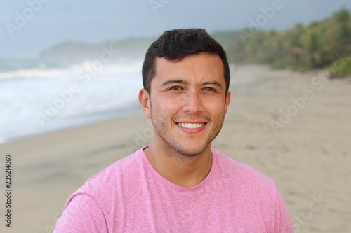 Man smiling at the beach with copy space