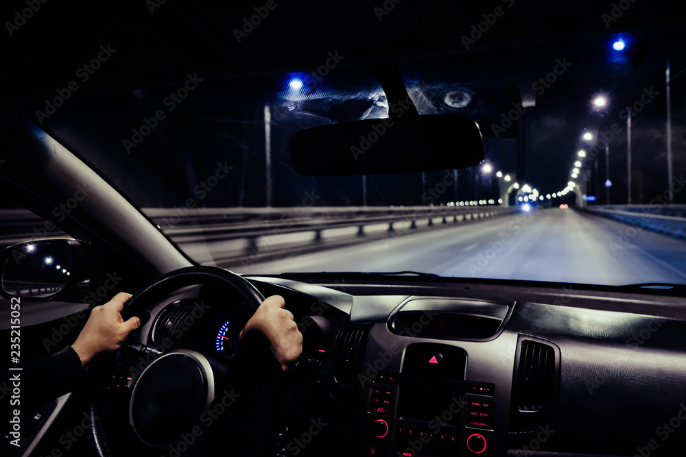 Obraz premium driving a car at night on the way 