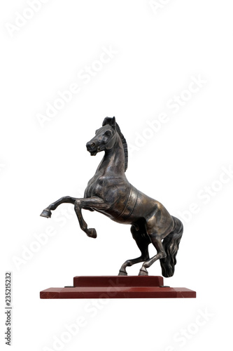 A metal figure of a horse on a pedestal of red marble on a white background. Isolated.