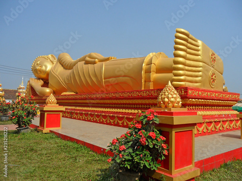 Hugh Golden Reclining Buddha Image at Wat That Luang Tai Temple, Part of PhaThat Luang Complex in Vientiane, Laos  photo