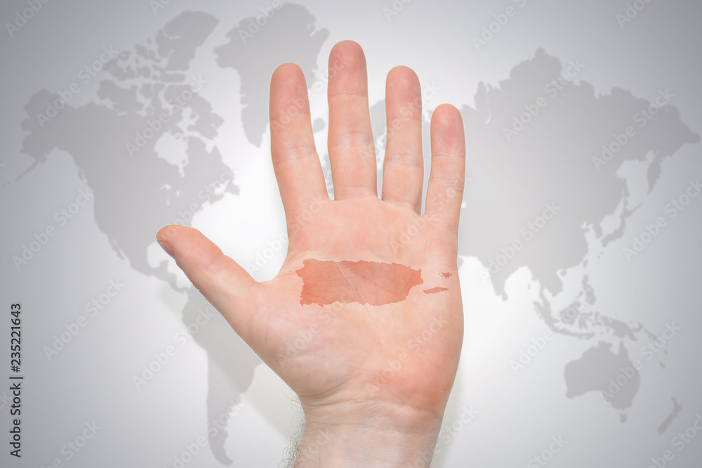 hand with map of puerto rico on the gray world map background. Stock