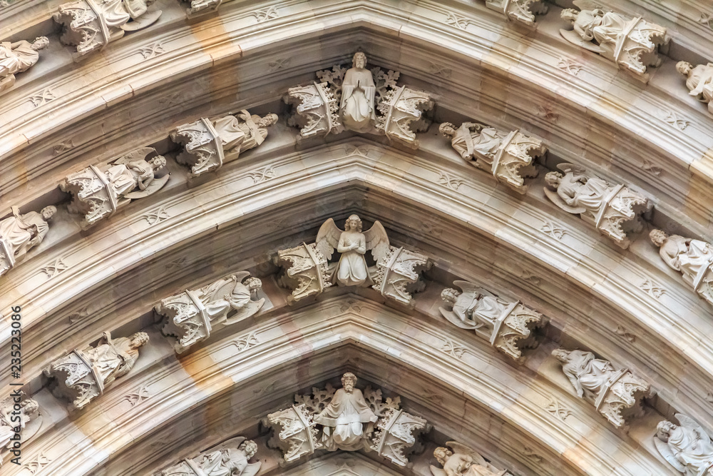 Gothic detail of cherubs on the facade above the main gate of Cathedral of the Holy Cross and Saint Eulalia, or Barcelona Cathedral in Barcelona, Spain