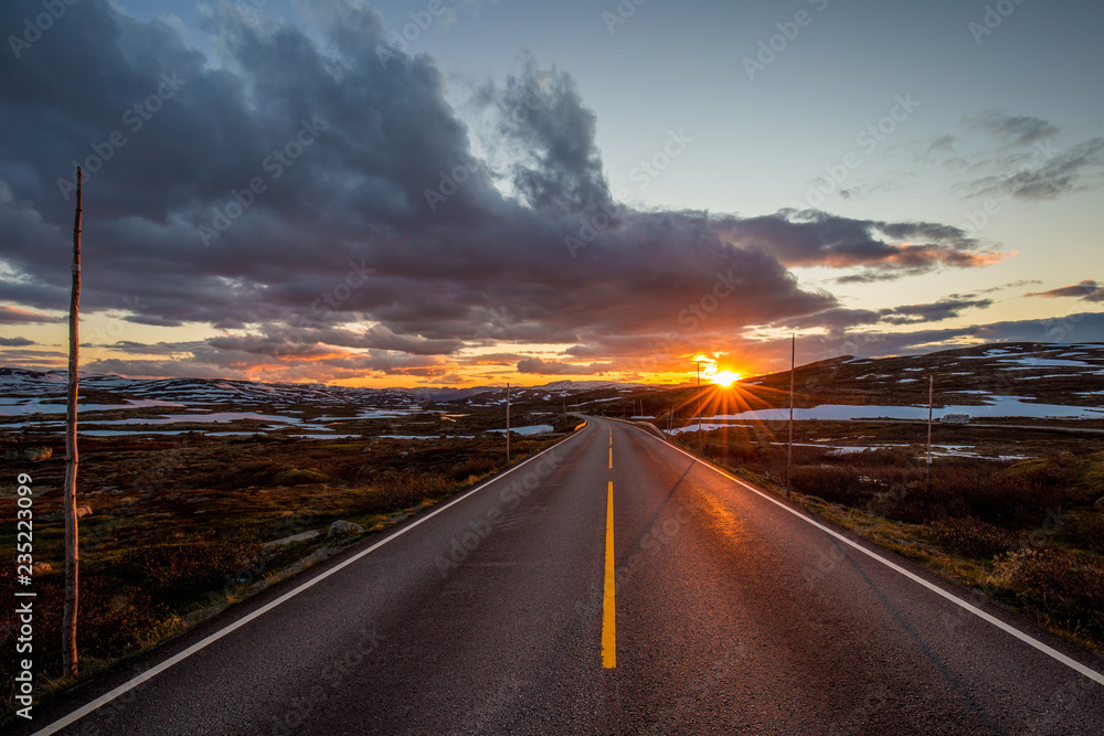 Sunset over lonely road in highlands in Norway