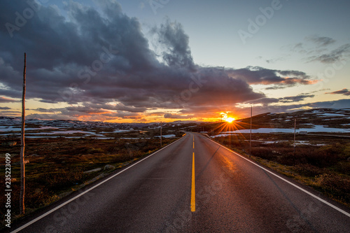 Sunset over lonely road in highlands in Norway