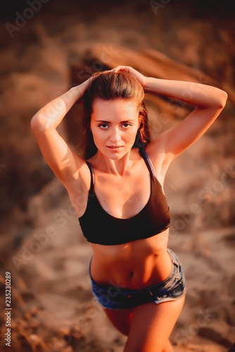 Wallpaper Mural Beautiful girl in shorts in a sand quarry. Torontodigital.ca