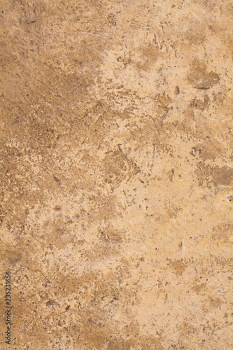 Brown Sandstone surface with space for your text. Vintage light brown wall color with gradient transition for your advertising in the vertical version. The texture of the wall of an ancient building.