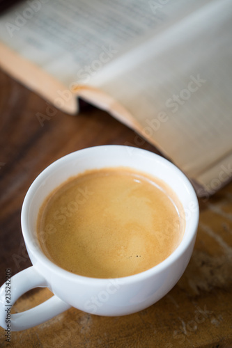 Hot americano coffee book background on wood table