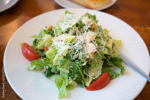 Fresh healthy Caesar salad on white plate