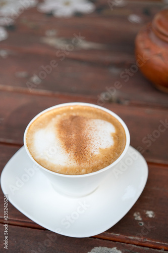 Hot coffee cup on wooden table