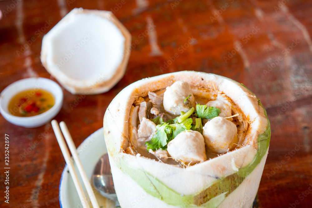 The noodles are served in a coconut. The noodles are served in a coconut.