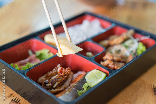 bento box with sushi and rolls