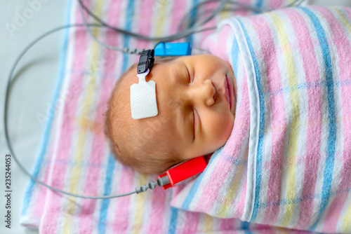 hearing test of a sleeping newborn at hospital