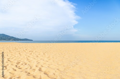 Landscape view of empty tropical Mai Khao beach and blue sea under blue sky with white cloud 