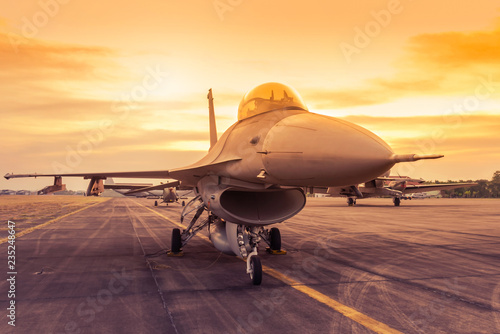 fighter jet military aircraft parked on runway standby ready to take off on sunset