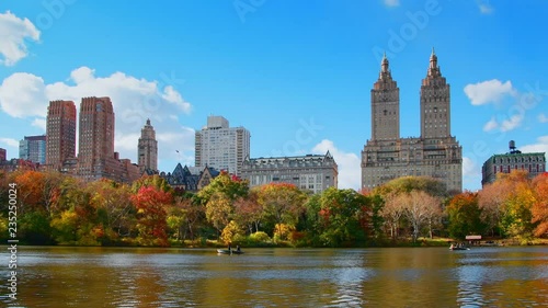 Boating in New York City Central Park in Autumn with skyscrapers apartment and lake