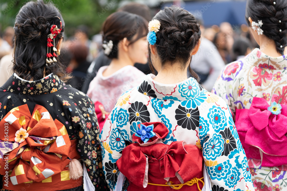 Young girl wearing Japanese kimono standing in front of Sensoji Temple in Tokyo, Japan. Kimono is a Japanese traditional garment. The word Young girl wearing Japanese kimono standing in front of Sensoji Temple in Tokyo, Japan. Kimono is a Japanese traditional garment. The word