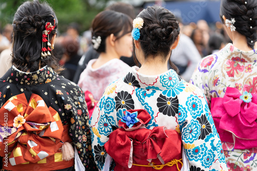 Young girl wearing Japanese kimono standing in front of Sensoji Temple in Tokyo, Japan. Kimono is a Japanese traditional garment. The word "kimono", which actually means a "thing to wear"