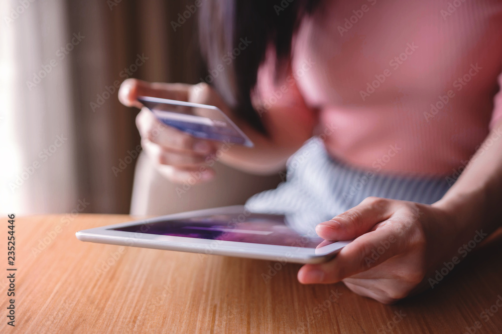 Woman Customer using Credit Card and Tablet to Shopping Online. Close-up shot and Selective focus