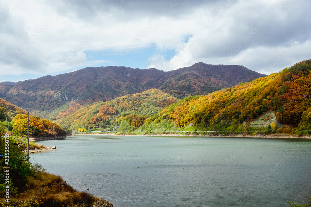 Beautiful mountain lake in the valley of the hills, in autumn, among thousands of colorful trees. Iwon Village, South Korea Beautiful mountain lake in the valley of the hills, in autumn, among thousands of colorful trees. Iwon Village, South Korea