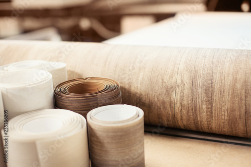 Rolls with brown wood texture. Production of doors