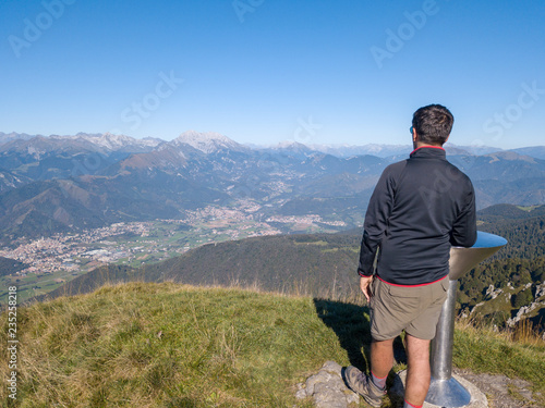 Person is looking at the Alps from the summit of the mountain © Matteo Ceruti