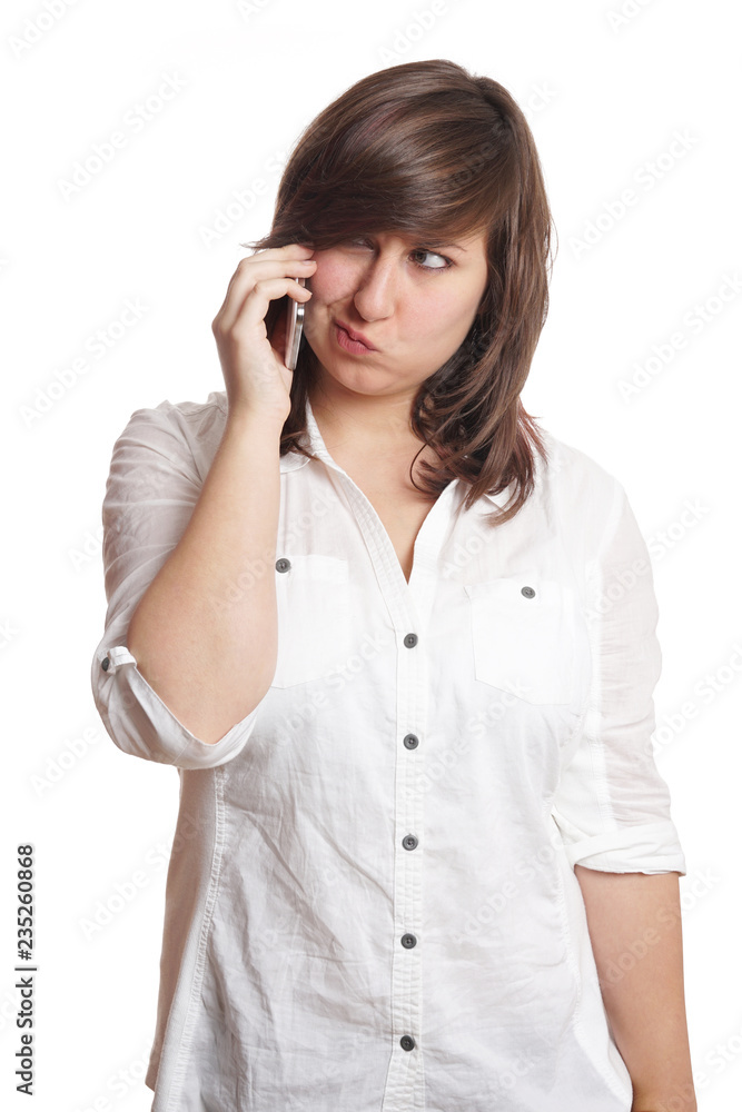 young woman making a face while on mobile phone call young woman making a face while on mobile phone call