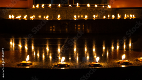Thai styled candles called Pangpratis or Pangpratheep and made from clay, wax and cotton are lit and placed on the ground around the building during Loy Krathong or Yeepeng festival in Chiang Mai