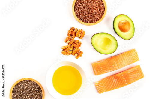 Food, rich in omega-3 fatty acids. Raw salmon, avocado, walnuts, chia and flax seeds, shot from the top on a white background with a place for text