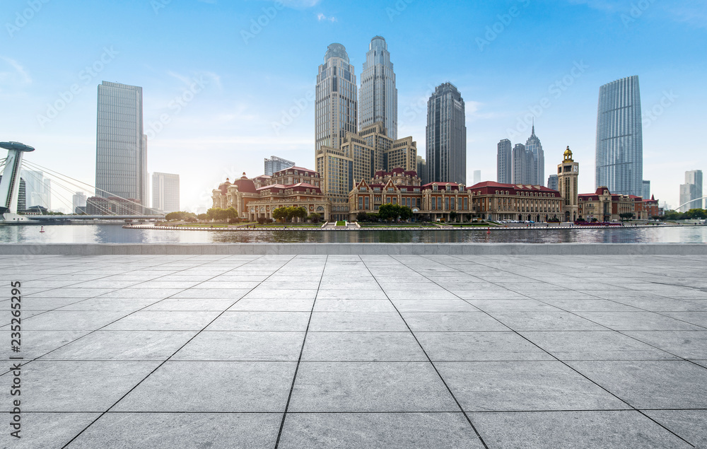 empty tiled floor and urban skyline,tianjin china.