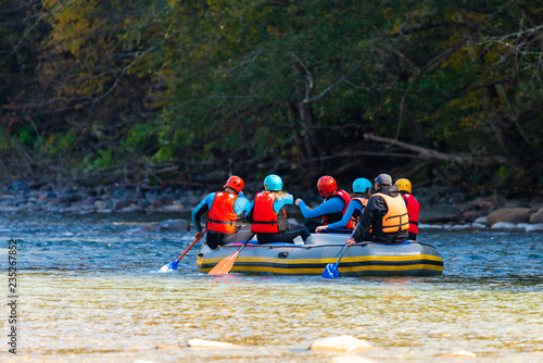 Group of young people make a rafting on mountain river © rostovdriver