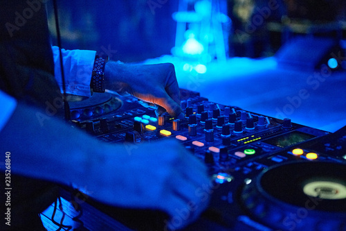 Dj hands mixing track outdoor at party festival nightlife view of disco club outside photo