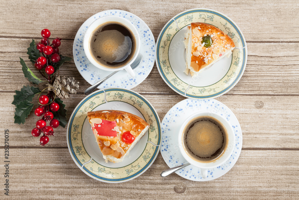 Two cut pieces of Spanish typical dessert of epiphany with coffee
