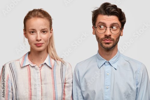 Photo of attractive blonde woman with pony tail, curious unshaven guy stand s...