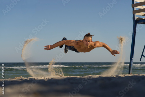 Man doing  workout at a beach on a sunny day