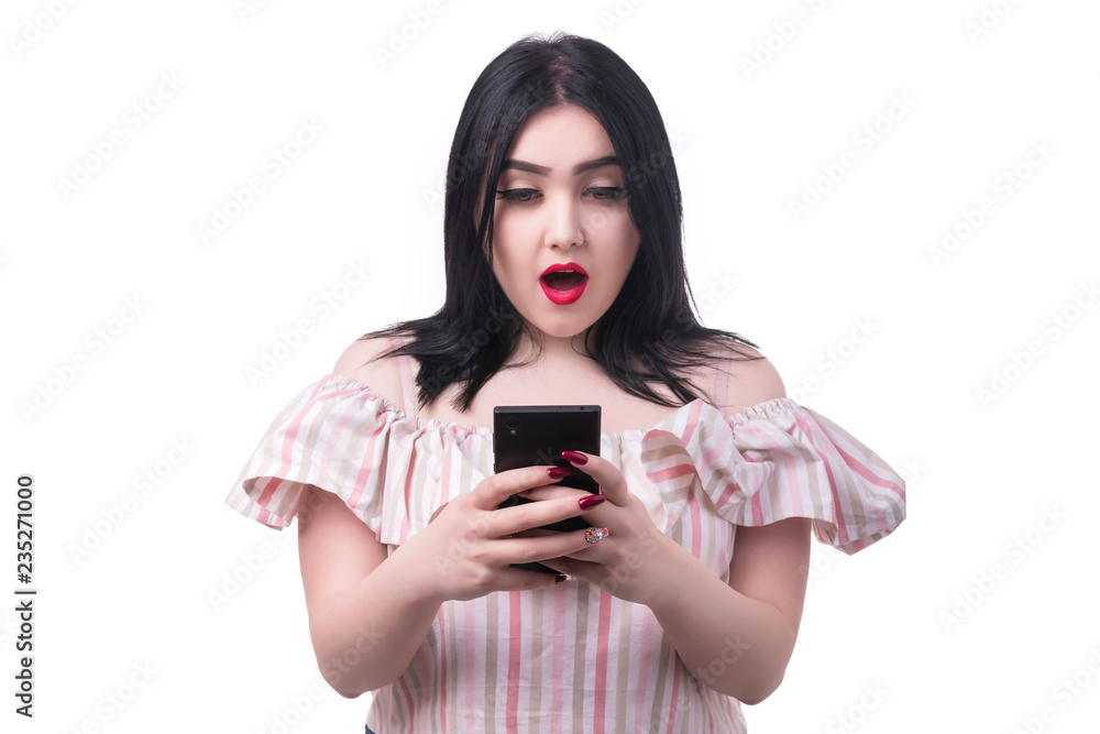 plus size model looks into the phone with shocked emotion, isolated on white background plus size model looks into the phone with shocked emotion, isolated on white background