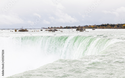 The view across the Horseshoe Falls, a part of the Niagara Falls, viewed from the Canadian side. The falls straddle the border between America and Canada.