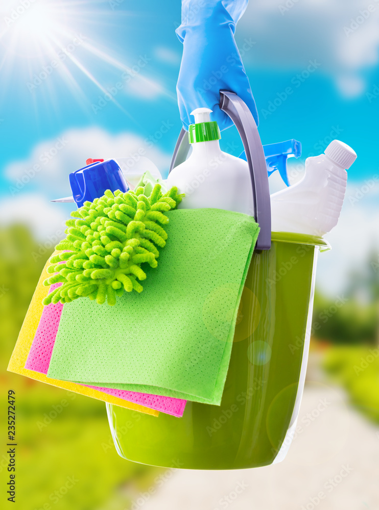Cleaning concept of cleaning supplies needed to spring cleaning. Cleaning equipment at spring background.