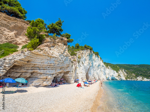 APULIA, IT - Jul 19, 2018: Mattinata Faraglioni stacks and beach coast of Baia Delle Zagare, Vieste Gargano, Apulia, Italy photo