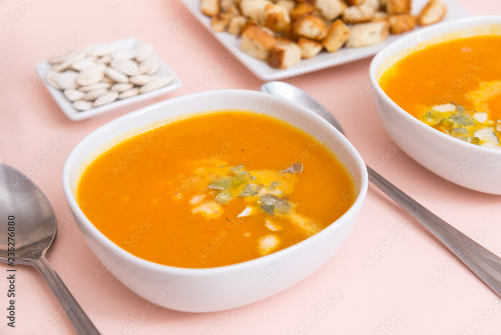 orange pumpkin soup in plates, spoons, vegetable soup orange pumpkin soup in plates, spoons, vegetable soup