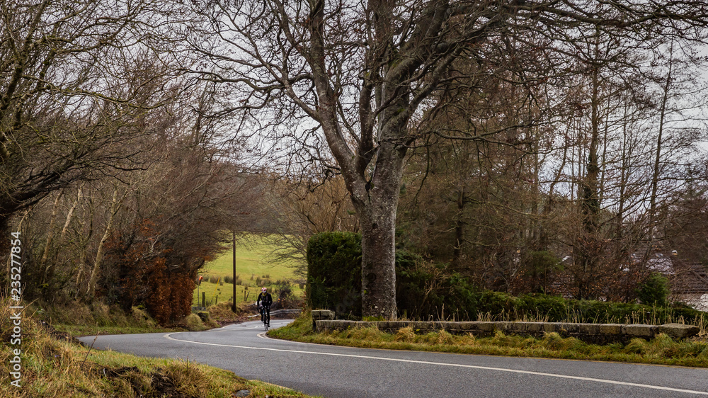 man rides road bicycle uphill man rides road bicycle uphill