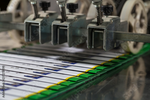 Folding machine industrial. Demonstration of the workflow. Equipment for color printing.